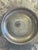 This round hammered aluminum bowl features four hand-chased rose motifs around a wide, ruffled scalloped rim, in the style...