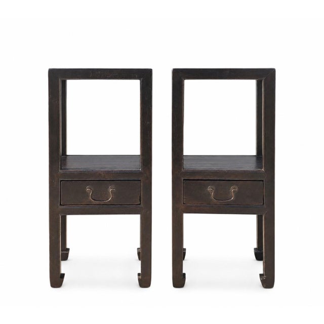 This antique pair of elegant Asian accent tables is made of solid elm. Finished in a rich, dark lacquer, each table...