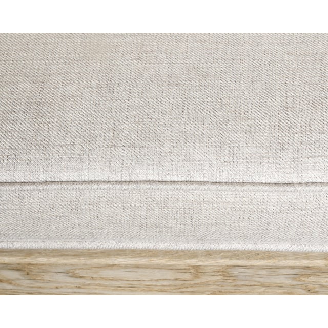 An English bleached oak bench from the 19th century with carved wooden back, downswept arms, cabriole legs and custom...
