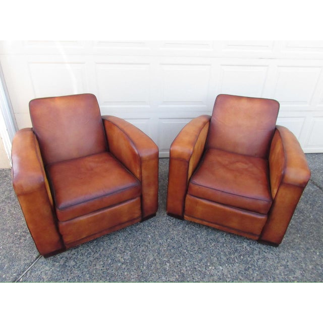 Pair of art deco style French leather club chairs, c.1950’s A handsome pair of leather club chairs in a warm honey brown...