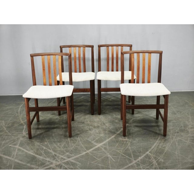 Exceptional set of four Danish dining chairs crafted from solid teak during the 1960s. Featuring elegant Scandinavian...