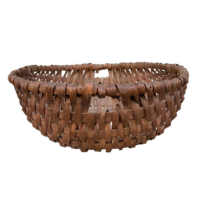 A wonderful and large 19th century American oak splint spale-form gathering basket with a bent wood ring and a handle on...
