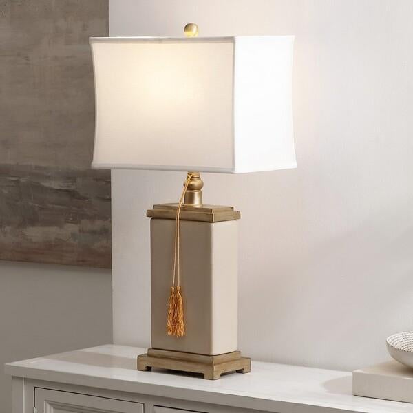 Illuminate your space with the charming amiliana tassel lamp in creme. Crafted from cream glazed ceramic, this lamp brings...