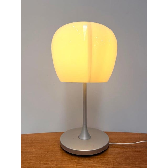 The IKEA Althorn table lamp is a timeless Scandinavian design featuring a softly illuminated frosted glass shade and a...