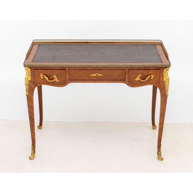 Louis XVI Style Kingwood Bureau Plat, with ormolu mounts, pierced galleried top and burgundy leather inset writing surface...