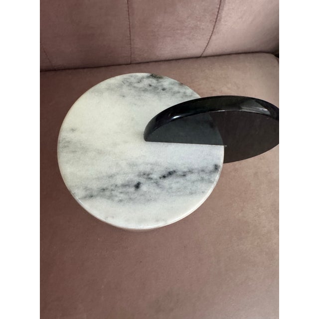 Elegant modern marble canister crafted from solid white marble with natural gray veining. The unique sculptural lid...
