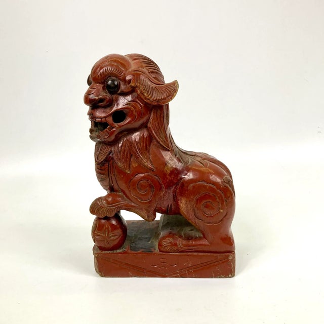 What a cute fellow! This red lacquer foo dog was carved out of one piece of wood. May have been used as an architectural...