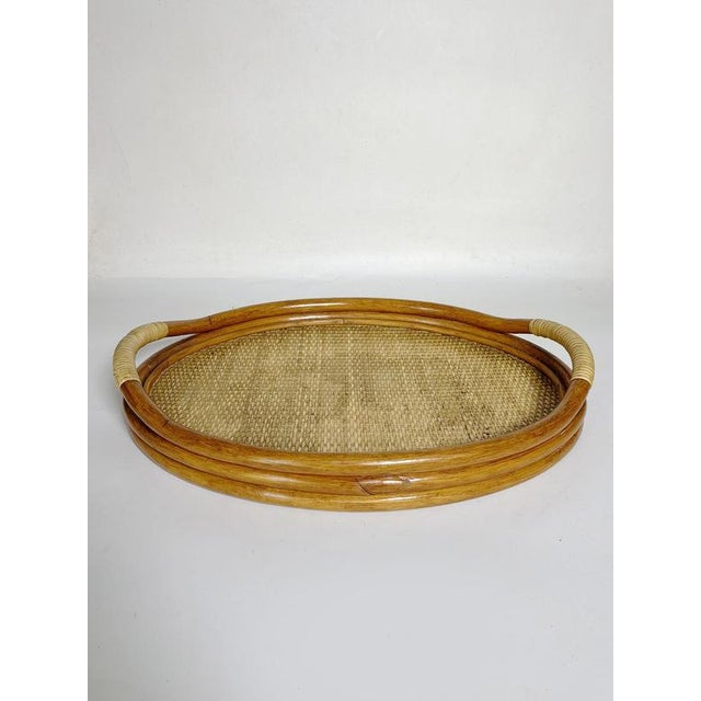 Oval wicker and rattan serving tray, France, 1960s. This elegant oval serving tray is crafted from bent rattan and woven...