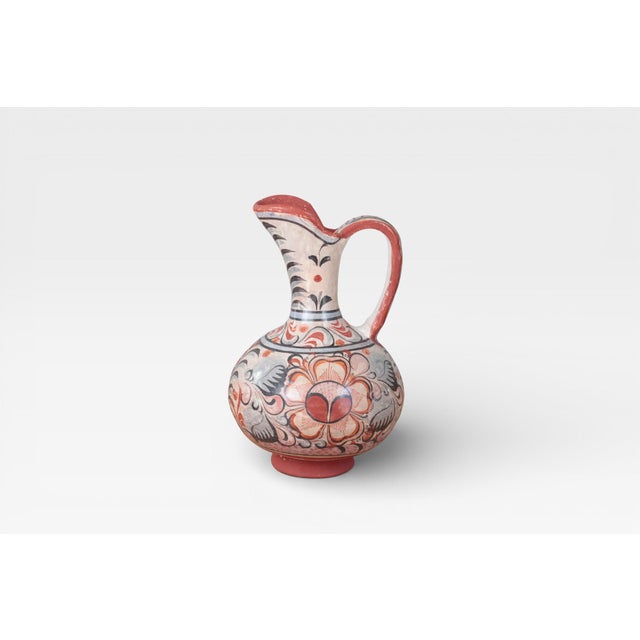 Vintage hand-painted ceramic pitcher from Tonalá, Mexico, decorated with traditional floral and foliate motifs in red,...