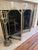 A stylish vintage eight-piece fireplace set: (1) a brass and wire four-part folding screen with brass trim, finials and...