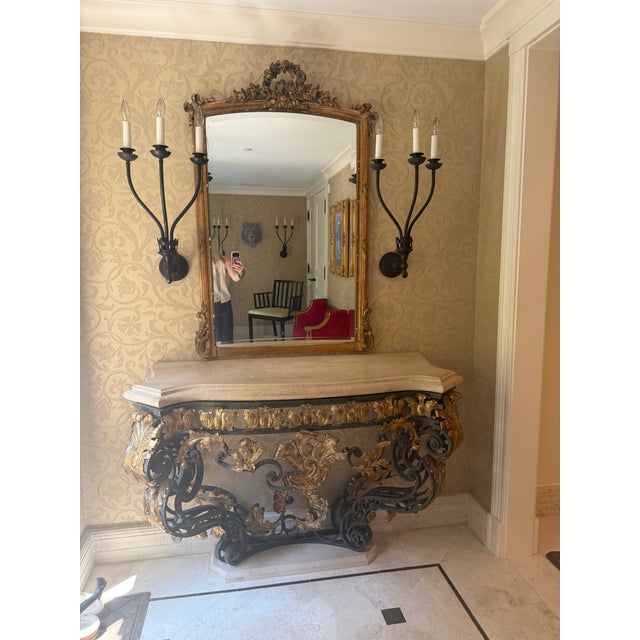 This exquisite gilt‑iron console table features hand‑forged scrollwork, patinated gold leaf accents, and a beautifully...