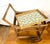 A delightful vintage wicker serving cart showcasing beautifully woven craftsmanship and a timeless silhouette. The cart...