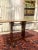 An elegant Danish teak dining table from the 1960s, crafted from warm-stained teak veneer with a simple rectangular top...