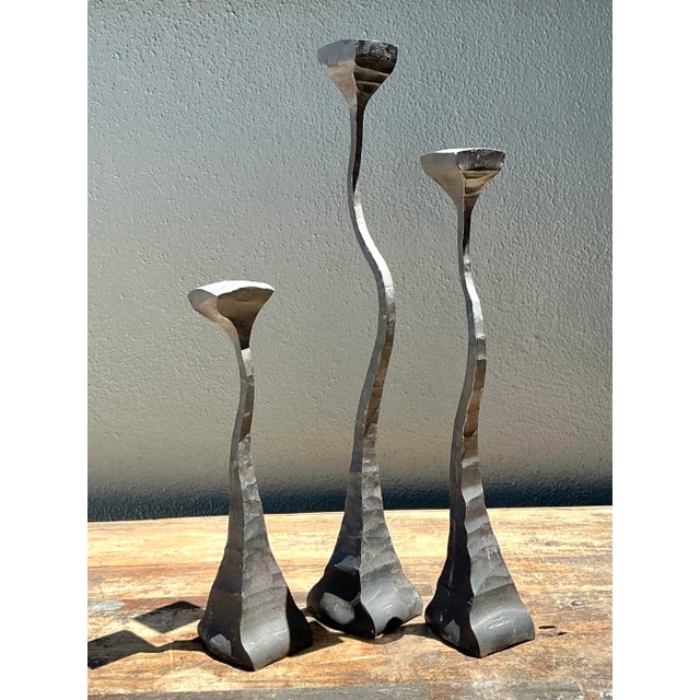 This exceptional set of three hand-hammered iron candlesticks, dating to 1988, is a masterclass in Postmodern artisan...