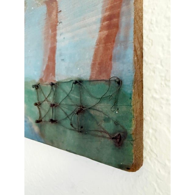 Traditional folk art mixed media painting depicting a lush landscape accented with fence made from wire and nails. Paint...