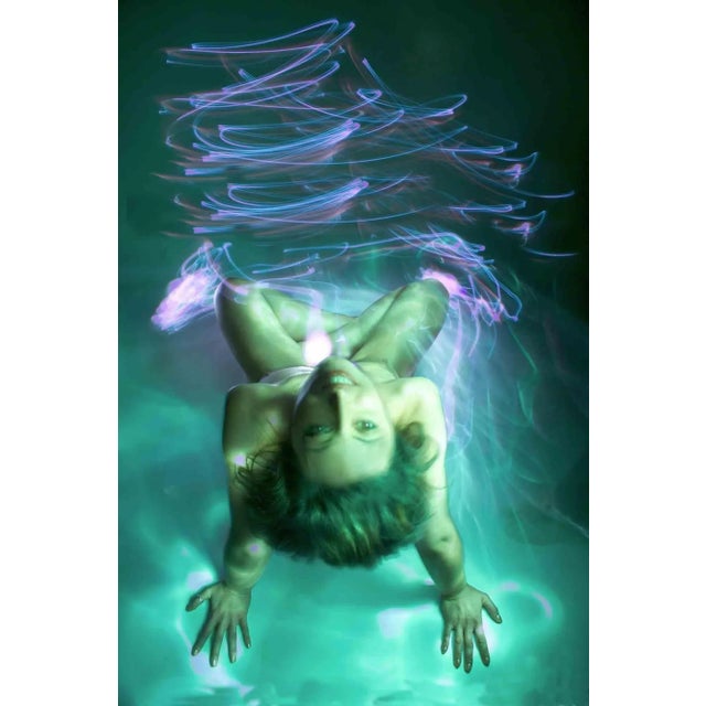 Light painting technique, realized in the dark duck studio, whertiother "paint" by torch with light of different colours,...