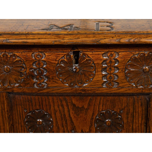 An English oak wedding coffer from the late 17th century, with carved rosettes and iron inlaid monogram. Created in...