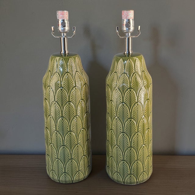 These ceramic table lamps feature a tropical banana leaf pattern in a vibrant green color, adding a touch of exotic flair...