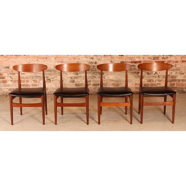 Set of 4 Mid Century teak dining chairs by Jentique, circa 1960s. The frames are cleaned and oiled. Original black vinyl...