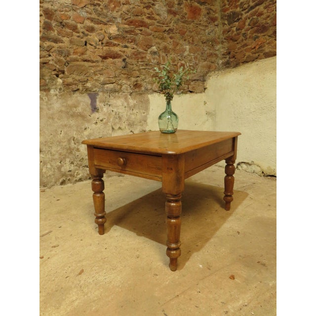 This is a charming little solid pine table dating to the 19th century. It is perfect for a small kitchen or dining room...