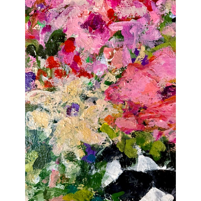 A vibrant bouquet bursts from a bold black and white vase in this impressionistic painting full of lively color and a...