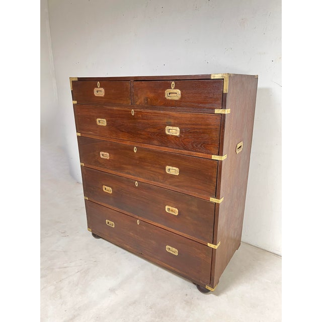 A mid 19th century British mahogany and brass bound campaign chest set upon bun feet, unusually tall for a campaign chest...