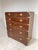 A mid 19th century British mahogany and brass bound campaign chest set upon bun feet, unusually tall for a campaign chest...