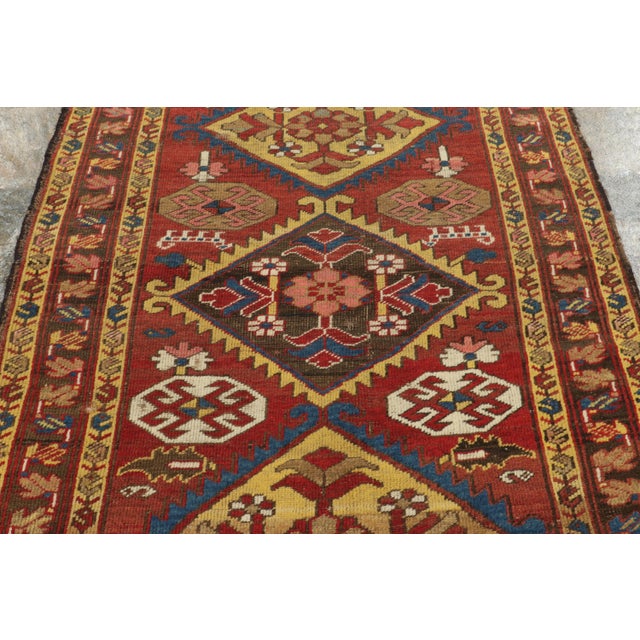 Originating from Northwest Persia circa 1920–1930, this hand-knotted antique wool runner is an exemplary survivor of the...