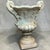 This is a pair of late 20th century neo-classical style cast stone planters. They have a timeless urn form and are in very...