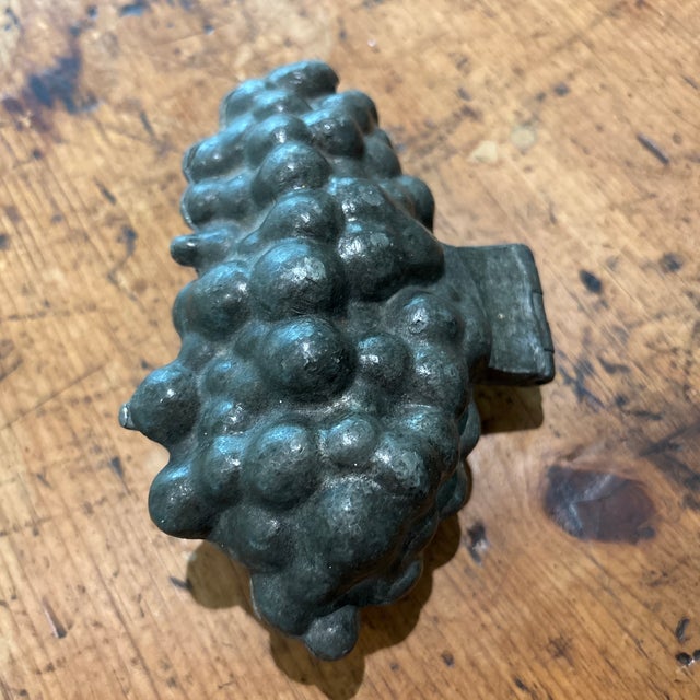 Vintage grape pewter mold, likely used for making ice cream or chocolate or candy in the shape of a bunch of grapes. It...