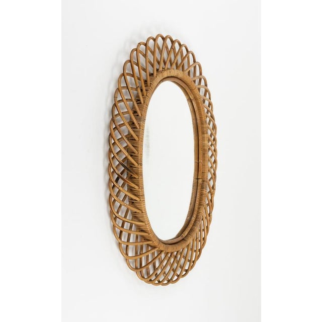 Midcentury amazing oval wall mirror in rattan and bamboo by Franco Albini. Made in Italy in the 1960s. Preserved in its...