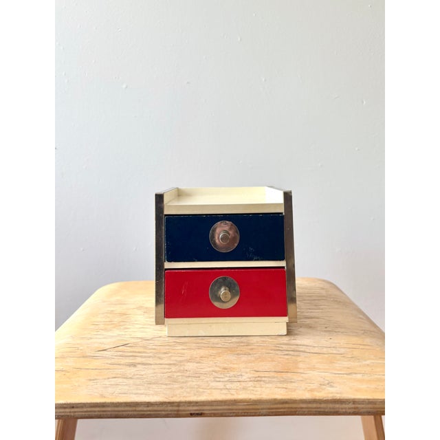 Vintage mid century modern miniature two drawer storage cabinet / jewelry box featuring bold red and navy blue drawer...