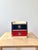 Vintage mid century modern miniature two drawer storage cabinet / jewelry box featuring bold red and navy blue drawer...