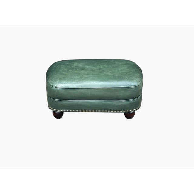 This elegant vintage leather ottoman captures the timeless appeal of classic English design with a rich, sophisticated...
