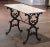 Crafted in southern France circa 1880, the antique table sits on a cast iron trestle base with elegant cabriole legs...