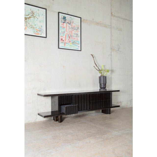 The Marino sideboard by Studio speziell® is characterized with its extruded ceramic form and a raw, glossy glaze in the...