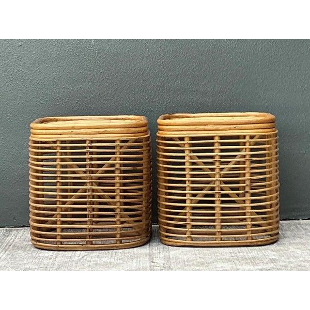 This pair of vintage side tables is a light, open study in bent rattan, built as compact, rounded-rectangle drums with a...