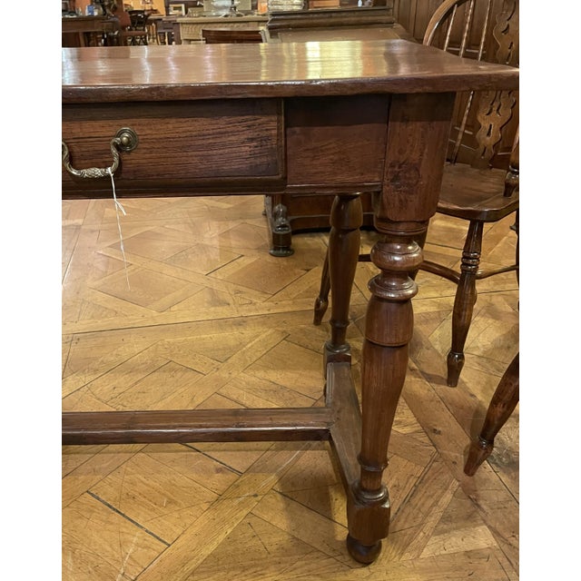 Charming small 19th-century chestnut desk resting on a very elegant base with turned legs connected by stretchers and...