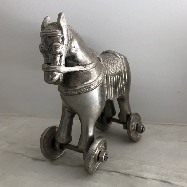 A finely detailed silver-tone metal horse on wheels to enliven any decor. Doesn’t even need hay or a stable! Excellent...