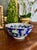 Chinese porcelain bowl decorated in the famille rose palette with a deep cobalt-blue ground, featuring finely painted...