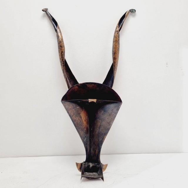 Chiwara mask, worn by African Bambara men during agricultural rituals. Wall relief made of red copper from the 1970s. It...