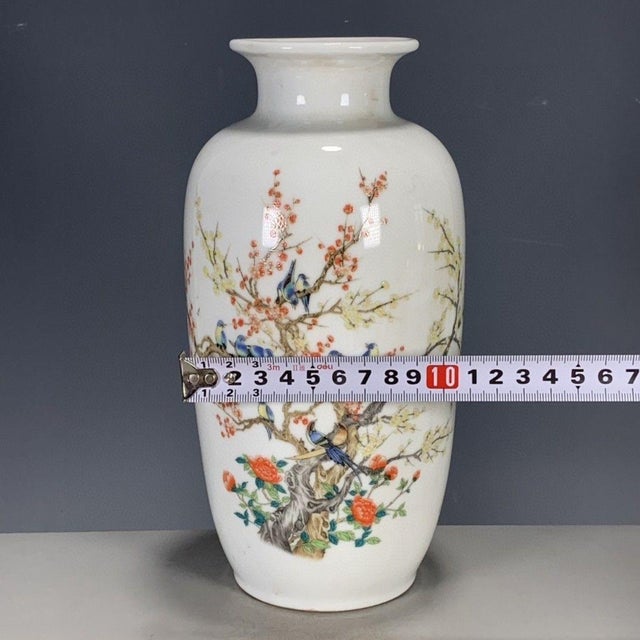 A lovely Chinese Famille Rose porcelain vase. The white ground is finely hand-painted with a lively scene of blue and...