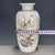 A lovely Chinese Famille Rose porcelain vase. The white ground is finely hand-painted with a lively scene of blue and...