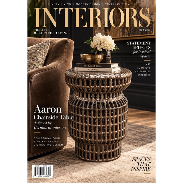 This is a cylindrical accent table featuring an intricate open-lattice design with a heavily textured, metallic-finished...