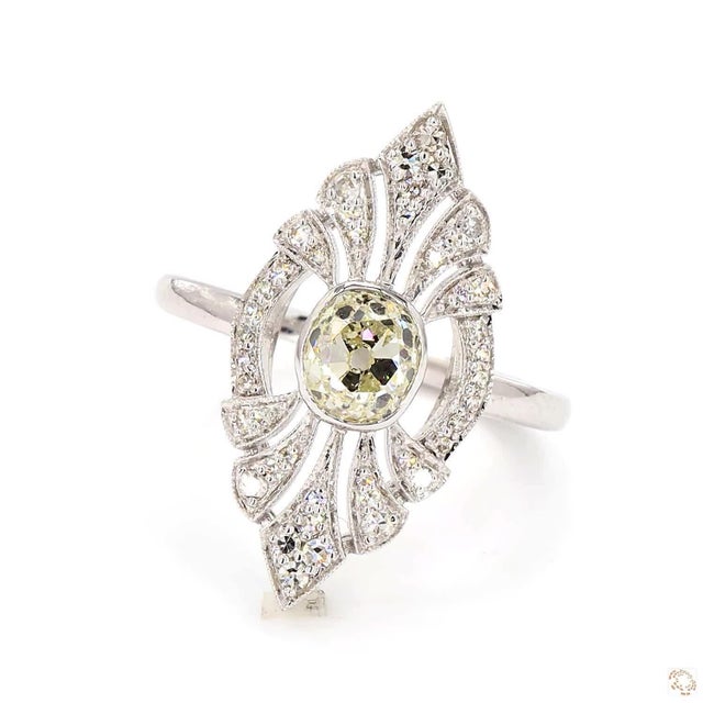 This statement ring, an early-twentieth-century antique design, centers on a 1.1-carat diamond in an old European cut, an...