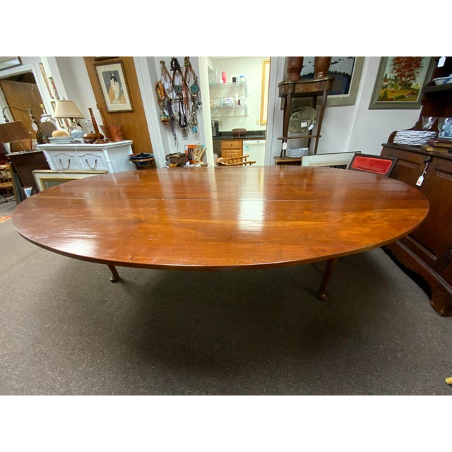 Large 20th century handcrafted hunt table with two drop leaf side, pad feet detail. Each drop leaf measures 212 inches....