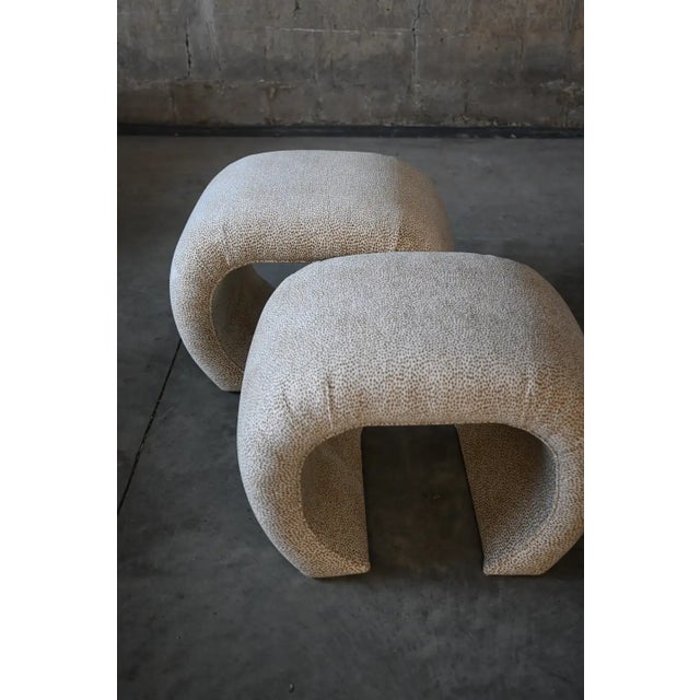 Iconic pair of waterfall scroll benches in the style of Karl Springer, upholstered in Kravet's Cheetah Spot chenille. The...