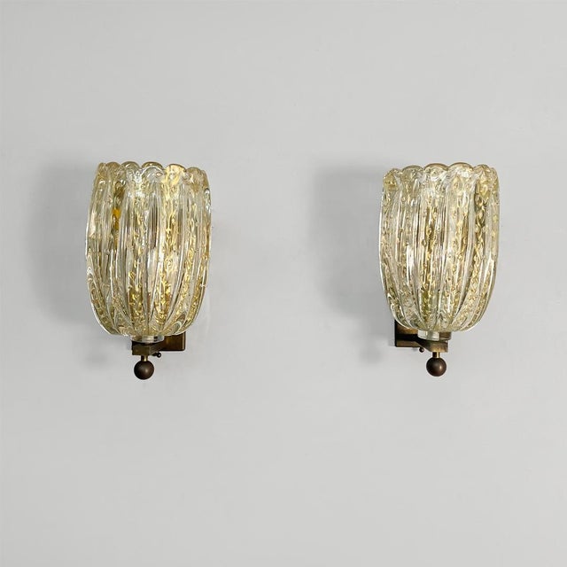 Italian Mid-Century Modern Murano glass wall lamps attributed to Barovier & Toso, 1950s. Pair of wall lamps featuring...