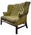 A showstopping vintage wingback settee upholstered in richly patinated olive green leather with dramatic button tufting...