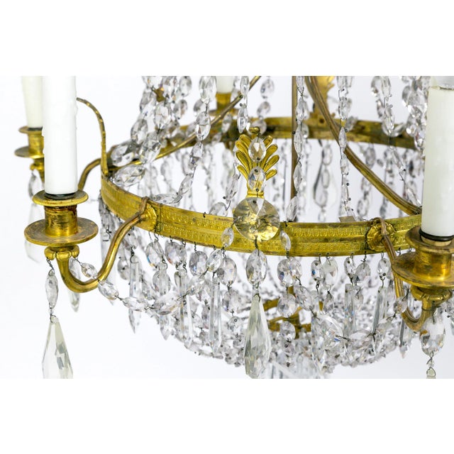 This Regency, tent and bag style, crystal chandelier has lovely brass fleurets, and crystal ropes, swags, and pendants;...